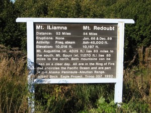 A sign on the road with info on Mt. Iliamma and Mt. Redoubt